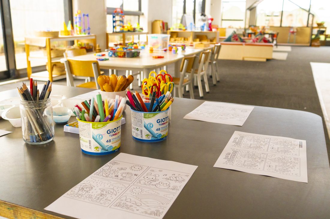 Art table with crayons and colouring sheets ready for tamariki