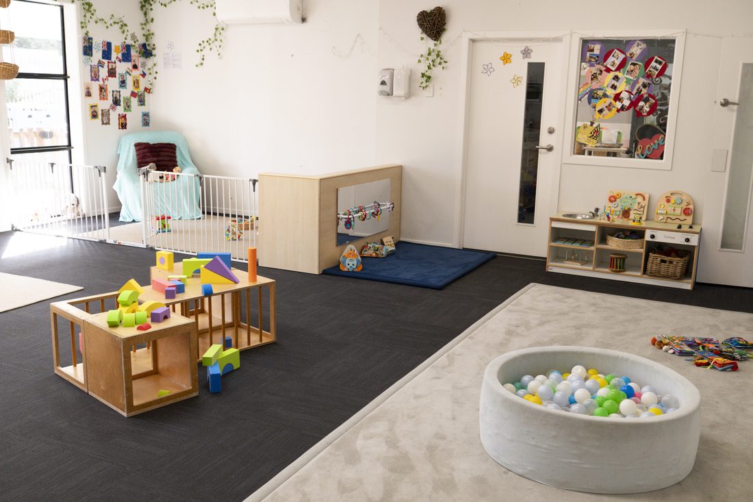 The Nest room with block play, a soft ball pit and low wooden furniture