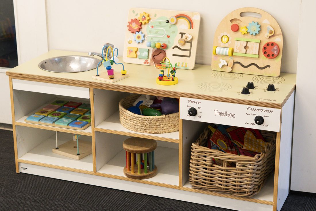 Wooden activity station with baskets and tactile toys