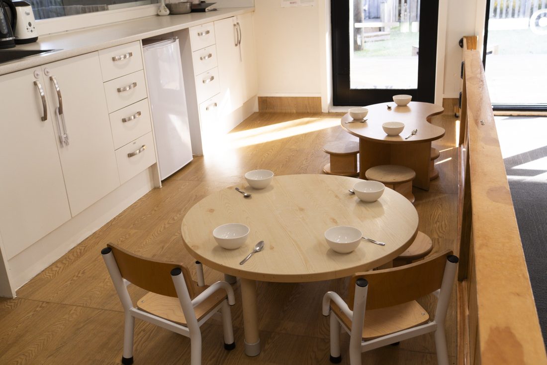 Round table set for morning tea in the Nest kitchen corner